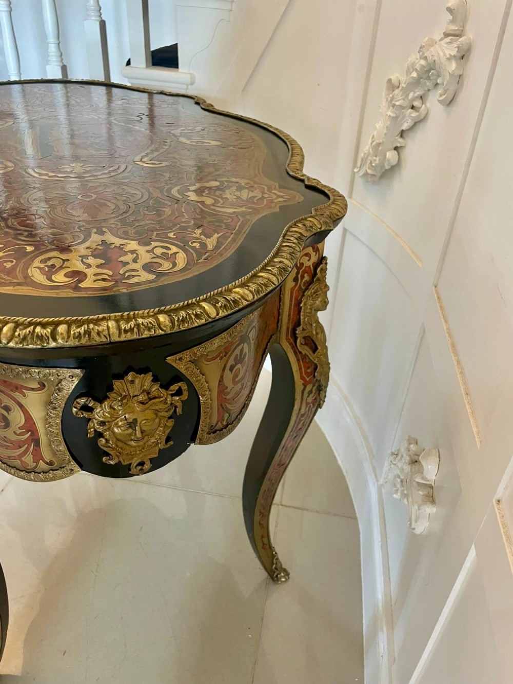 An antique French Louis XV style centre table featuring red tortoiseshell and brass Boulle marquetry, serpentine top, ebonised timber, and cast ormolu mounts on cabriole legs. View IV