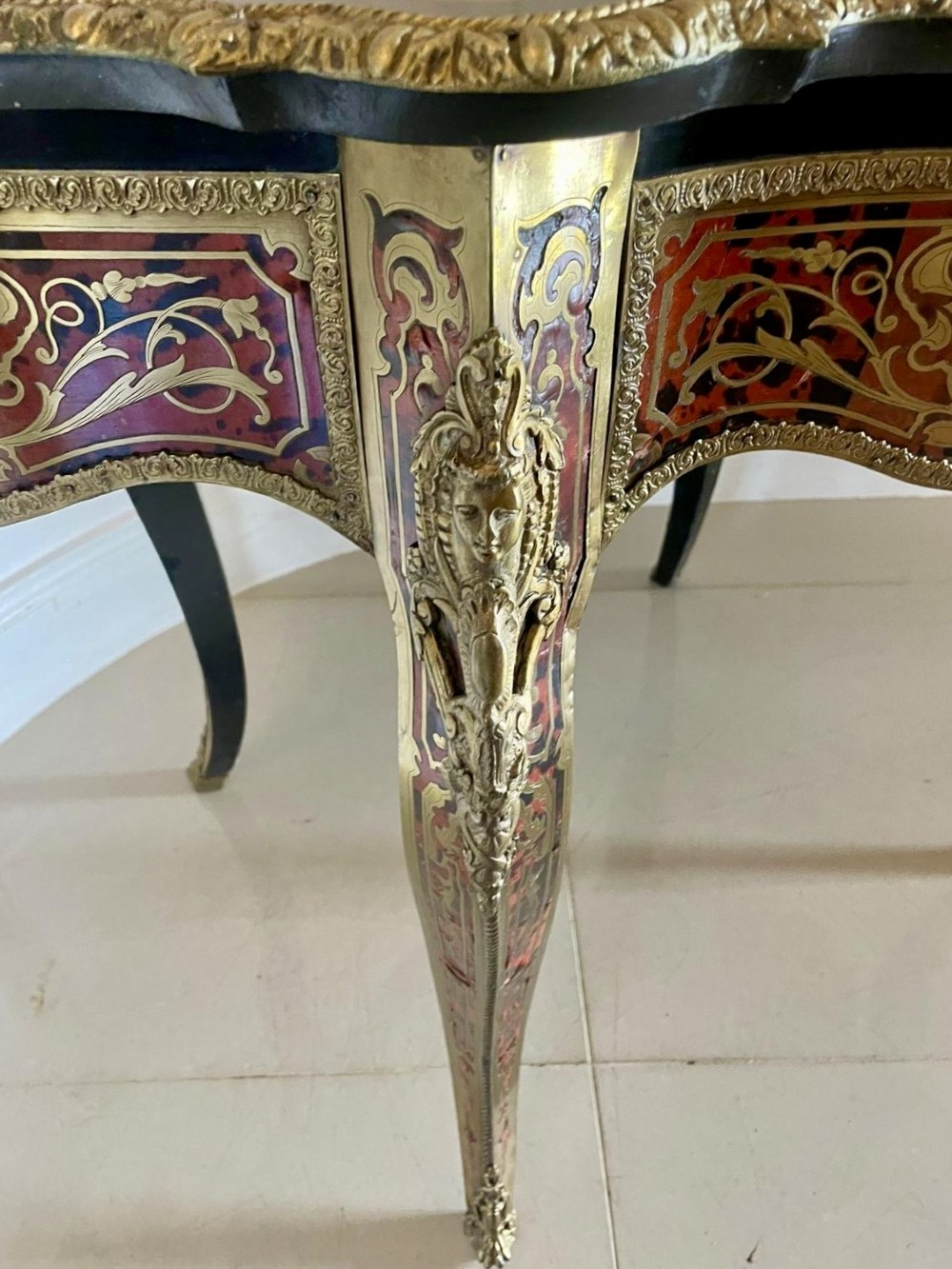 An antique French Louis XV style centre table featuring red tortoiseshell and brass Boulle marquetry, serpentine top, ebonised timber, and cast ormolu mounts on cabriole legs. View IX