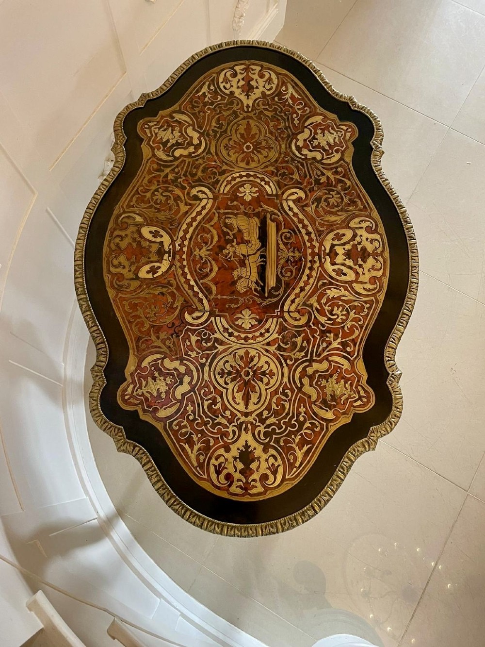An antique French Louis XV style centre table featuring red tortoiseshell and brass Boulle marquetry, serpentine top, ebonised timber, and cast ormolu mounts on cabriole legs. View XI