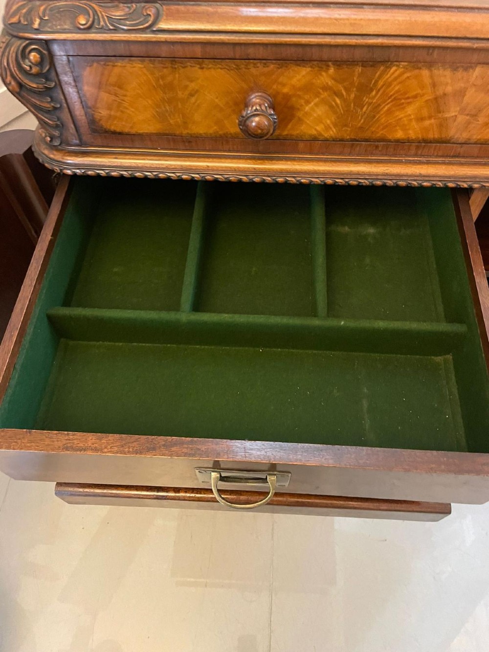 An antique burr walnut sideboard featuring quarter-veneered panel doors, carved edge mouldings, drawers with wooden knobs, and cabriole legs. View VI