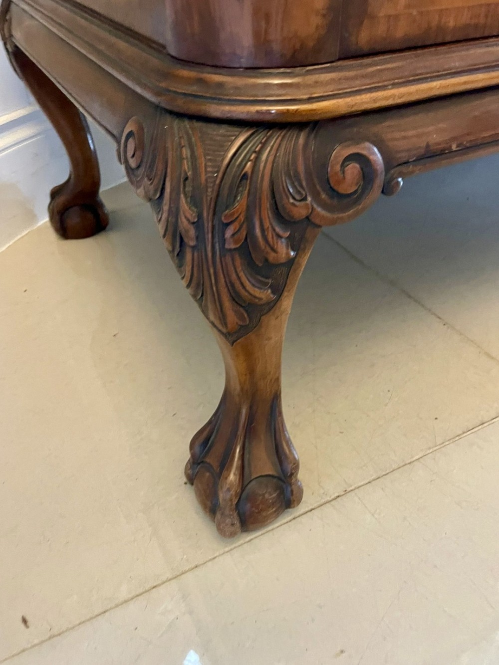 An antique burr walnut sideboard featuring quarter-veneered panel doors, carved edge mouldings, drawers with wooden knobs, and cabriole legs. View VIII