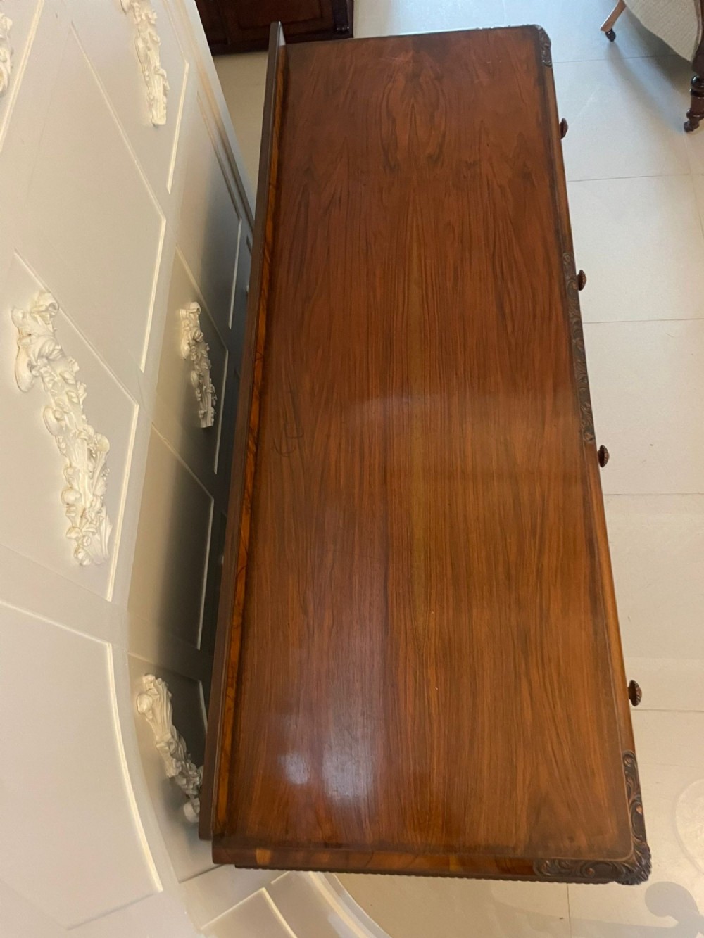 An antique burr walnut sideboard featuring quarter-veneered panel doors, carved edge mouldings, drawers with wooden knobs, and cabriole legs. View IX