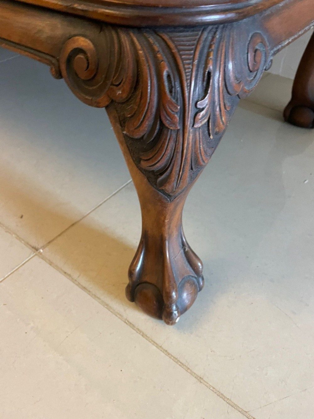 An antique burr walnut sideboard featuring quarter-veneered panel doors, carved edge mouldings, drawers with wooden knobs, and cabriole legs. View X