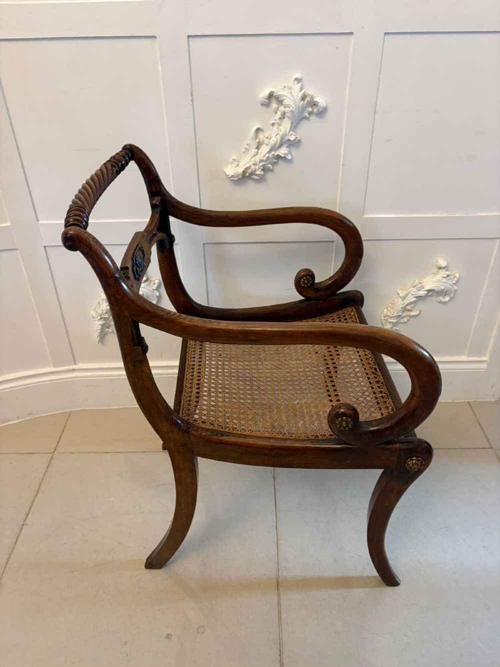 A set of six dark mahogany Regency dining chairs featuring rope-twist top rails, curved sabre legs, and woven cane seats. View V