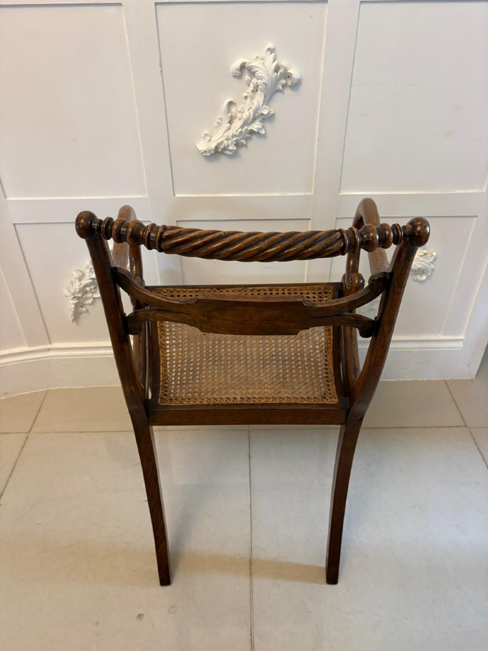 A set of six dark mahogany Regency dining chairs featuring rope-twist top rails, curved sabre legs, and woven cane seats. View VI