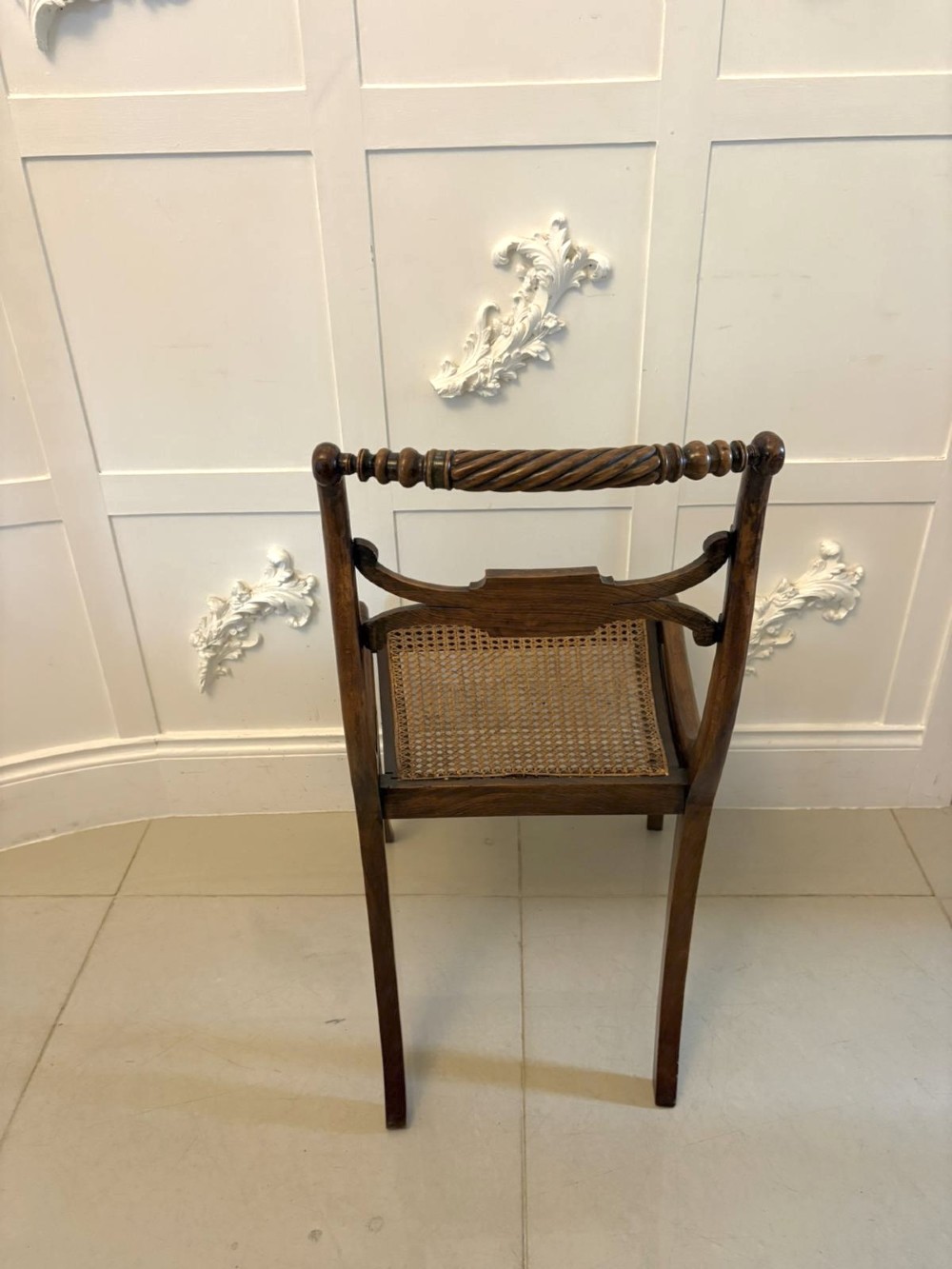 A set of six dark mahogany Regency dining chairs featuring rope-twist top rails, curved sabre legs, and woven cane seats. View VIII