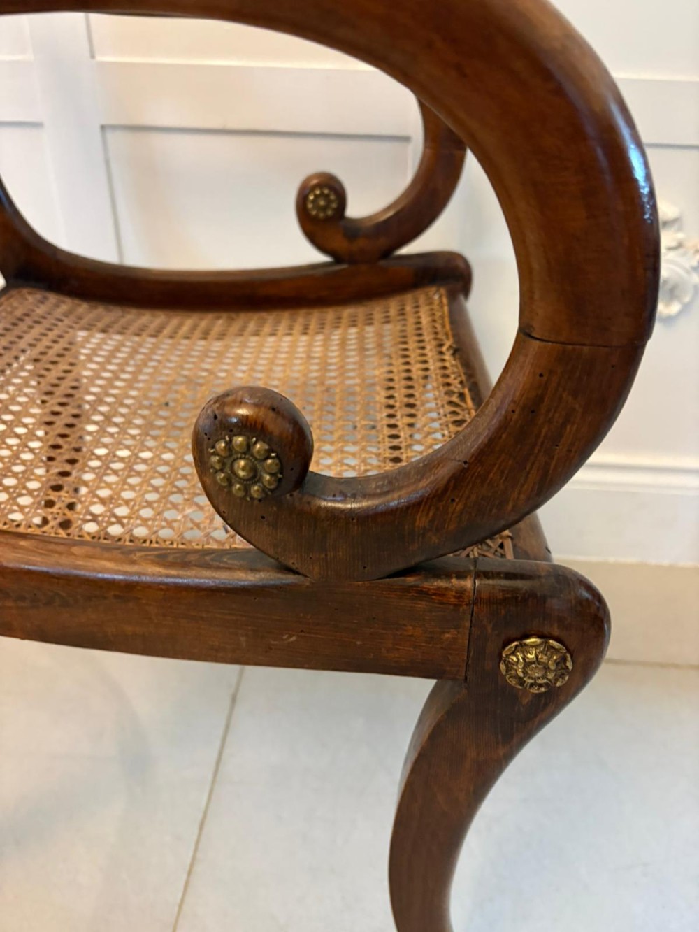 A set of six dark mahogany Regency dining chairs featuring rope-twist top rails, curved sabre legs, and woven cane seats. View IX