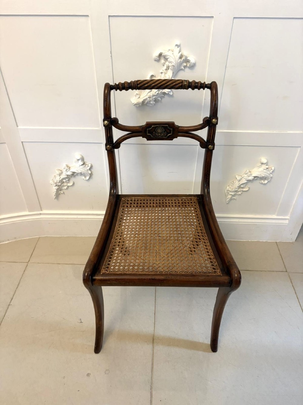 A set of six dark mahogany Regency dining chairs featuring rope-twist top rails, curved sabre legs, and woven cane seats. View XII