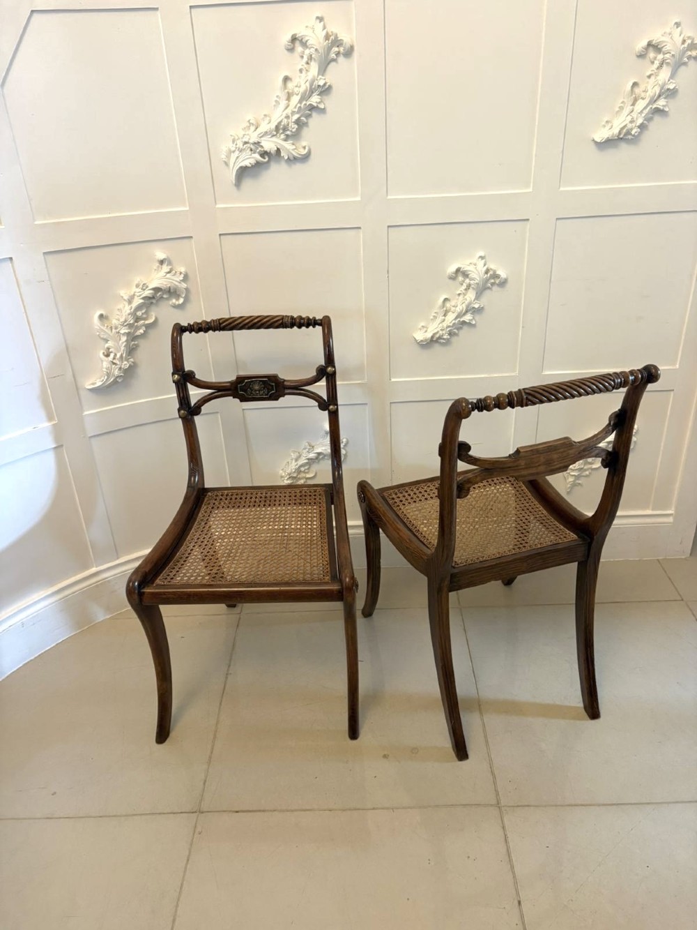 A set of six dark mahogany Regency dining chairs featuring rope-twist top rails, curved sabre legs, and woven cane seats. View XIV