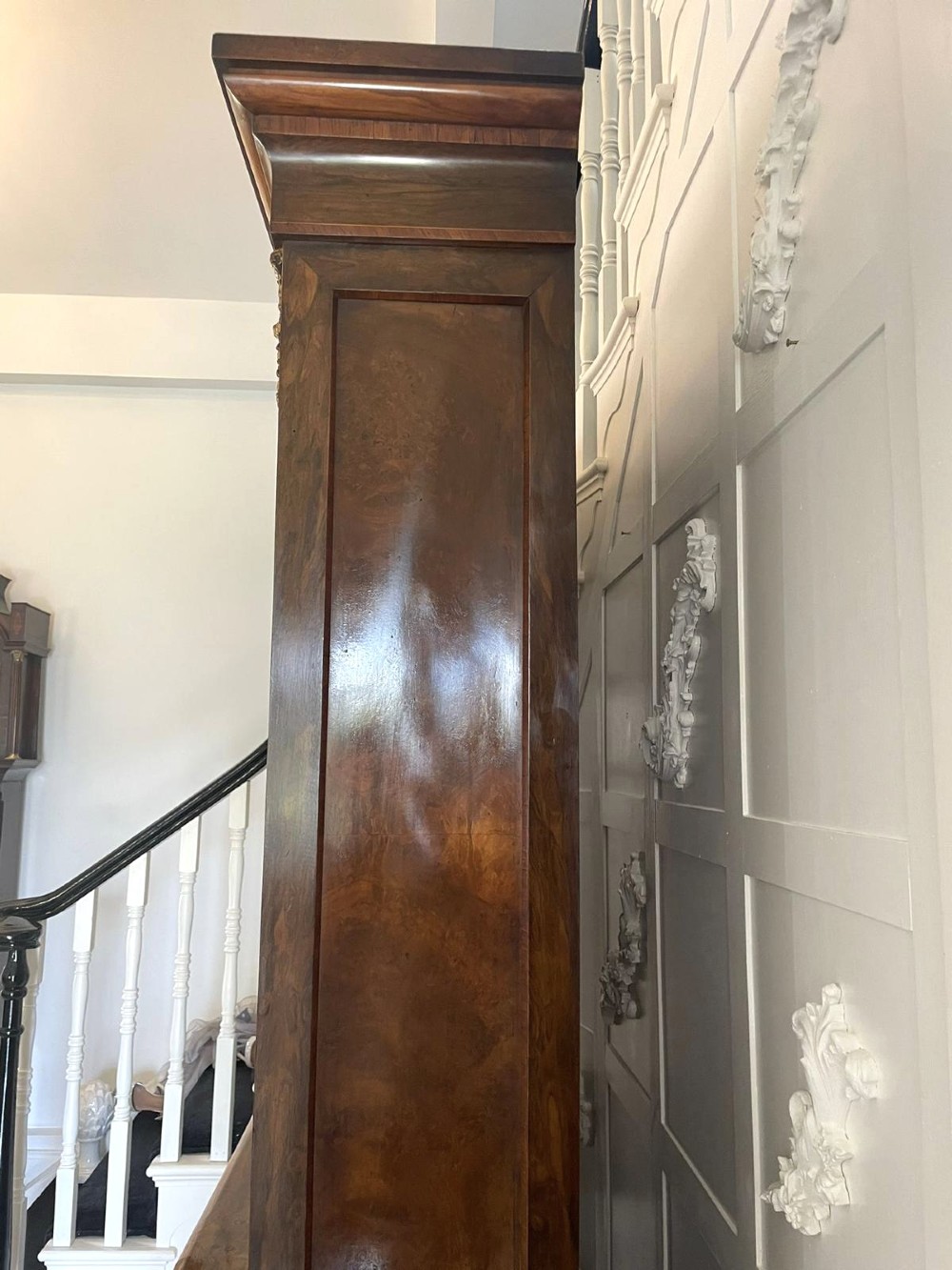 A Victorian two-part burr walnut bookcase cabinet featuring glazed upper doors with floral marquetry inlays and gilt ormolu mounts. View XII