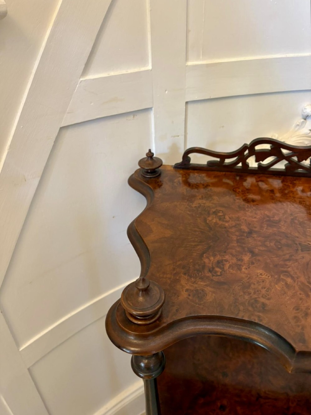 A pair of Victorian burr walnut three-tier whatnots featuring pierced fretwork galleries, serpentine fronts, and turned upright supports on castors. View VIII