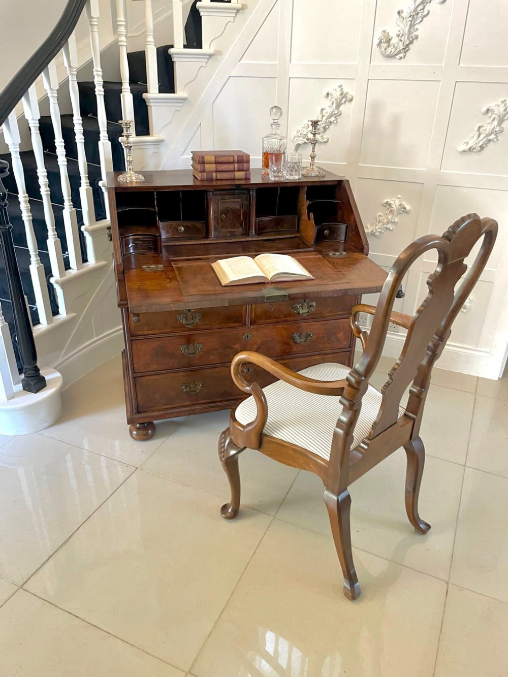 An antique burr walnut slant-front bureau featuring herringbone inlay, brass hardware, three lower drawers, and turned bun feet. View IX