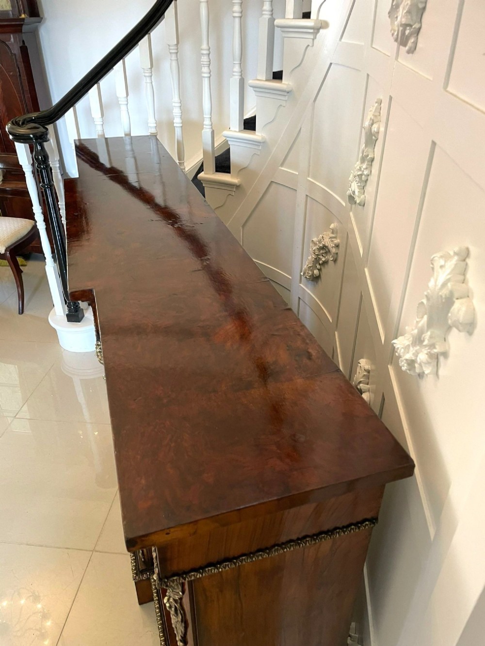 A Victorian burr walnut breakfront credenza featuring brass mounts, a central floral marquetry panel, and mirrored side doors. View X