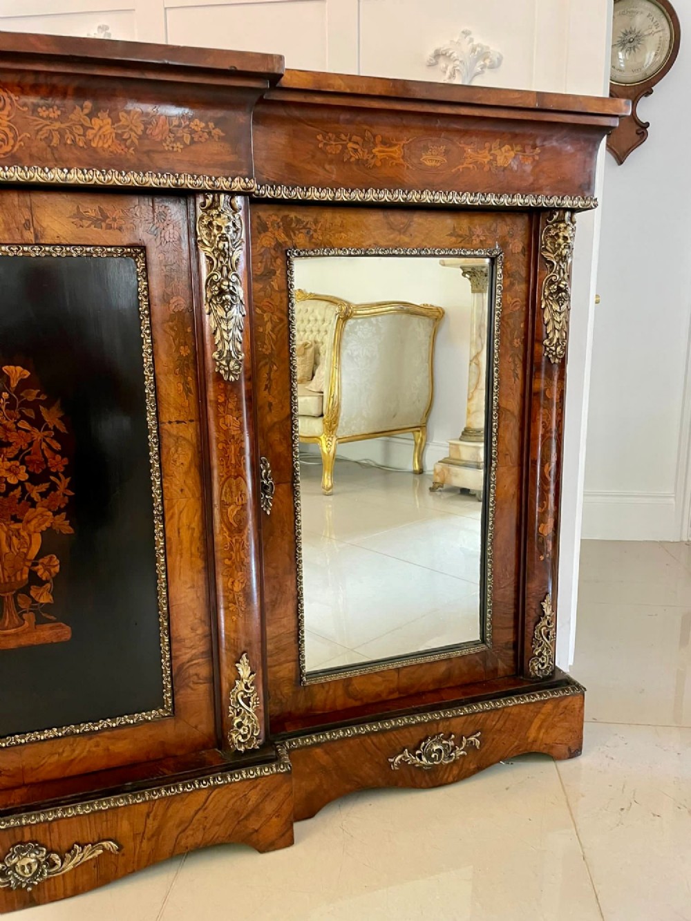 A Victorian burr walnut breakfront credenza featuring brass mounts, a central floral marquetry panel, and mirrored side doors. View XII