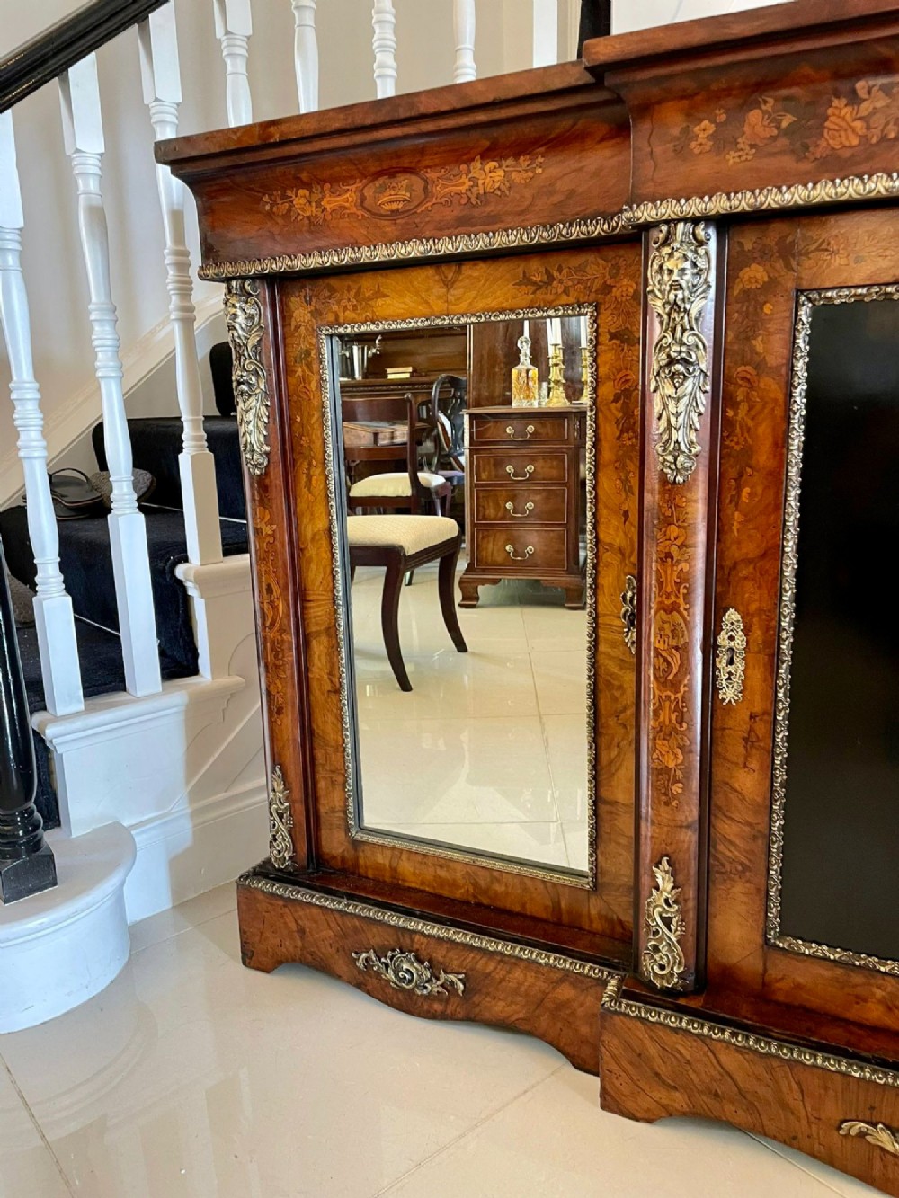 A Victorian burr walnut breakfront credenza featuring brass mounts, a central floral marquetry panel, and mirrored side doors. View XIII
