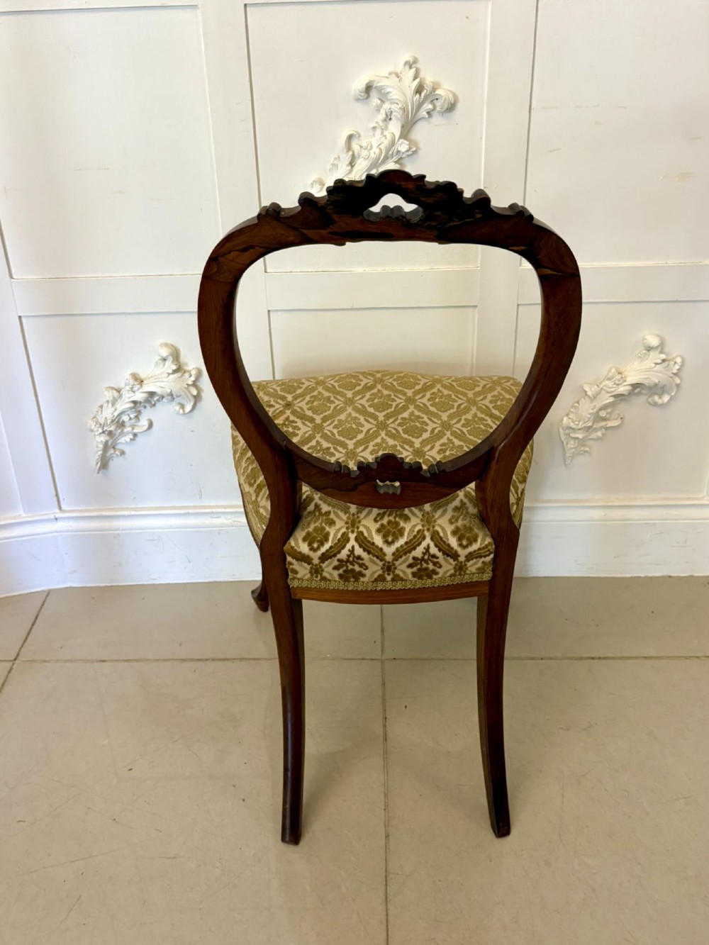 A set of six Victorian carved walnut dining chairs featuring open balloon backs, cabriole legs, and patterned green upholstered seats. View II