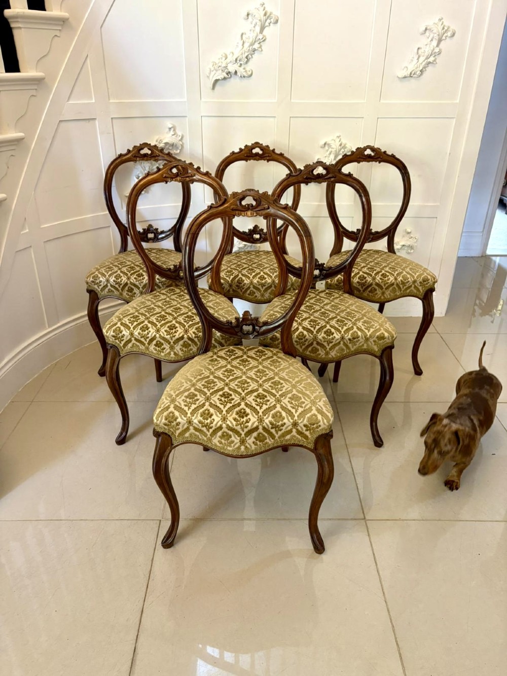 A set of six Victorian carved walnut dining chairs featuring open balloon backs, cabriole legs, and patterned green upholstered seats. View III