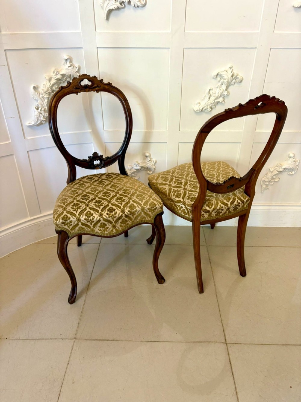 A set of six Victorian carved walnut dining chairs featuring open balloon backs, cabriole legs, and patterned green upholstered seats. View V