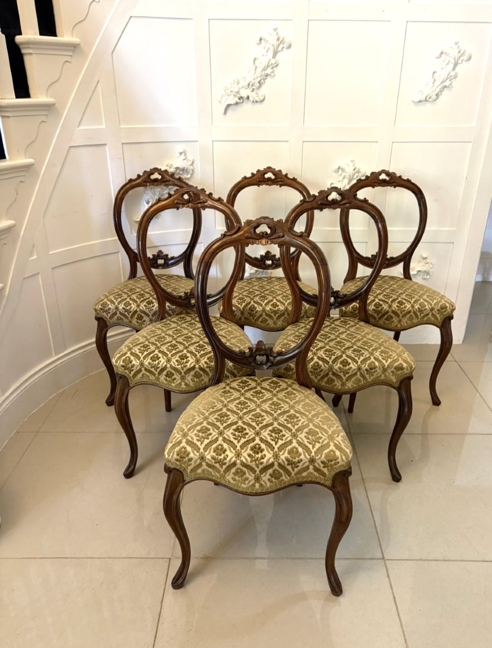 A set of six Victorian carved walnut dining chairs featuring open balloon backs, cabriole legs, and patterned green upholstered seats. View VIII