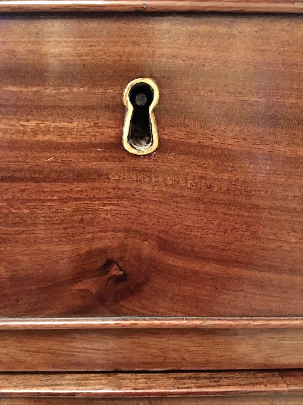A George III mahogany bureau featuring a sloping fall-front top above four graduated long drawers with brass swan-neck handles, resting on bracket feet. View II
