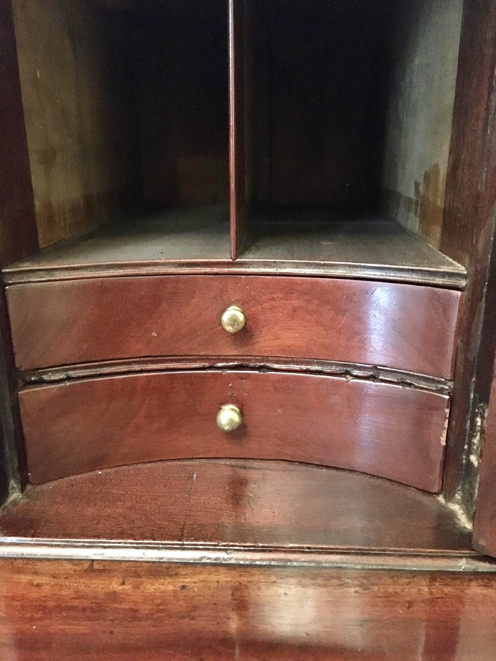 A George III mahogany bureau featuring a sloping fall-front top above four graduated long drawers with brass swan-neck handles, resting on bracket feet. View III