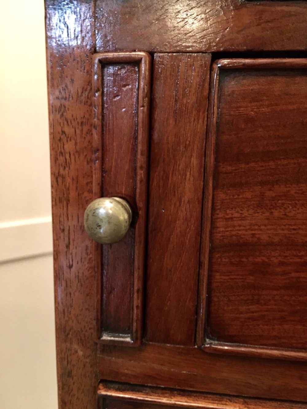A George III mahogany bureau featuring a sloping fall-front top above four graduated long drawers with brass swan-neck handles, resting on bracket feet. View V
