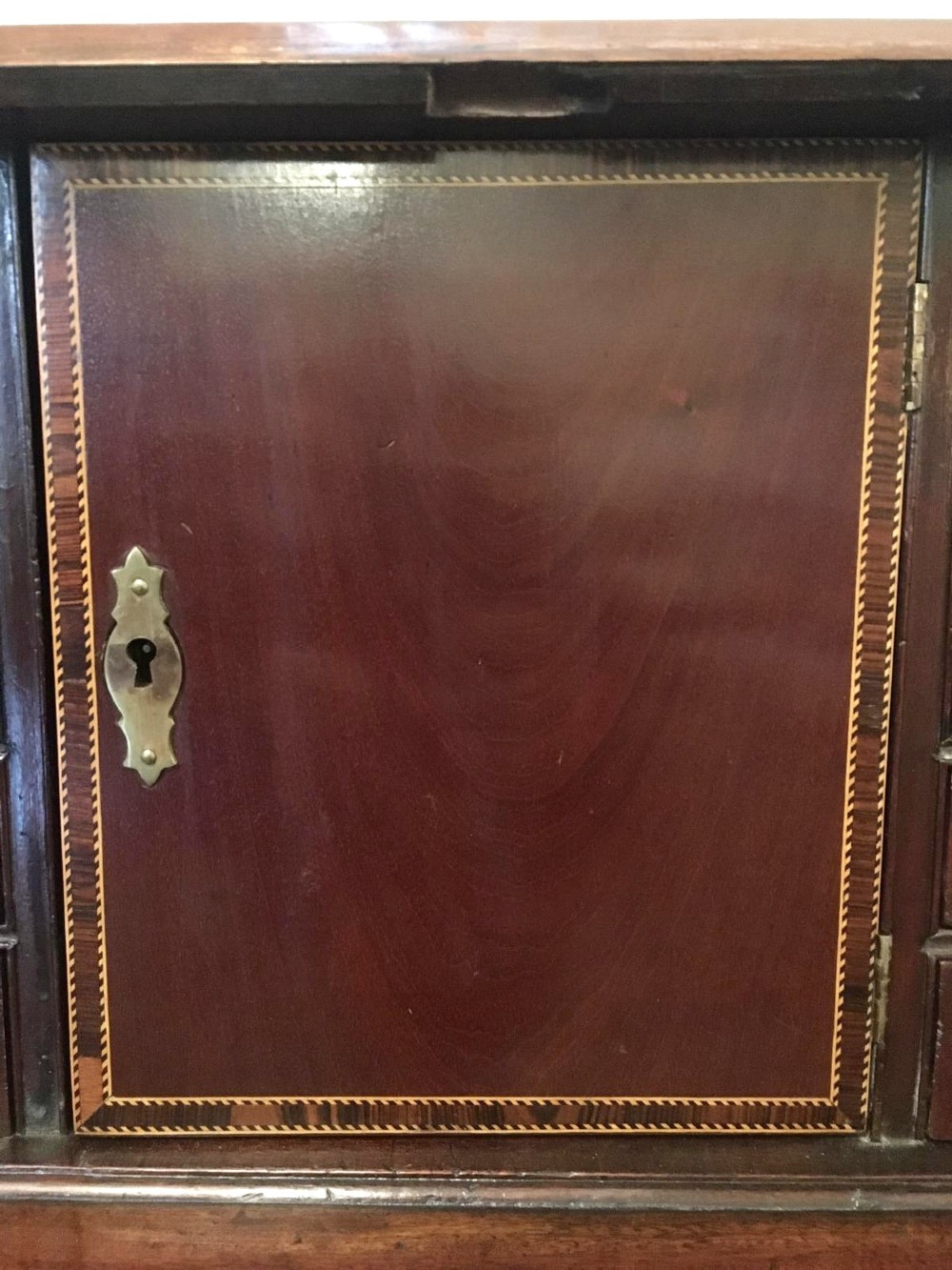 A George III mahogany bureau featuring a sloping fall-front top above four graduated long drawers with brass swan-neck handles, resting on bracket feet. View VI