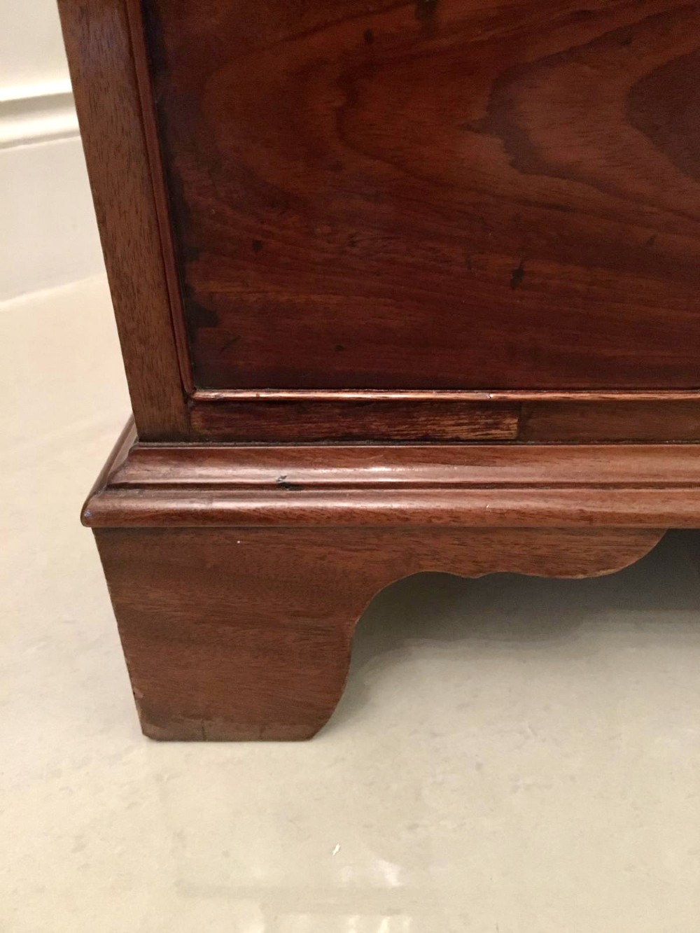 A George III mahogany bureau featuring a sloping fall-front top above four graduated long drawers with brass swan-neck handles, resting on bracket feet. View VIII