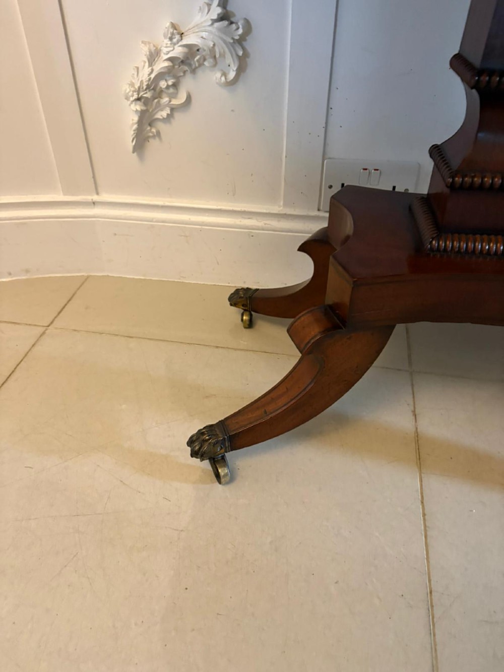 An antique Regency mahogany fold-over card table featuring brass marquetry inlay, a central shaped pedestal, and a splayed base with brass castors. View IX