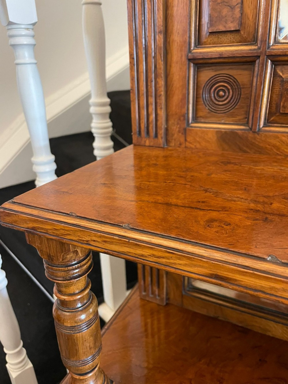 An antique Victorian pollard oak mirror-back sideboard featuring carved field panels, spindled galleries, and multiple mirrored sections. View VI