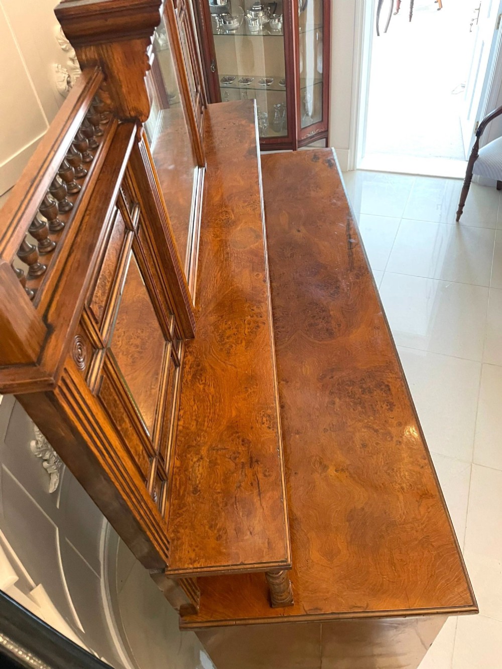 An antique Victorian pollard oak mirror-back sideboard featuring carved field panels, spindled galleries, and multiple mirrored sections. View VII