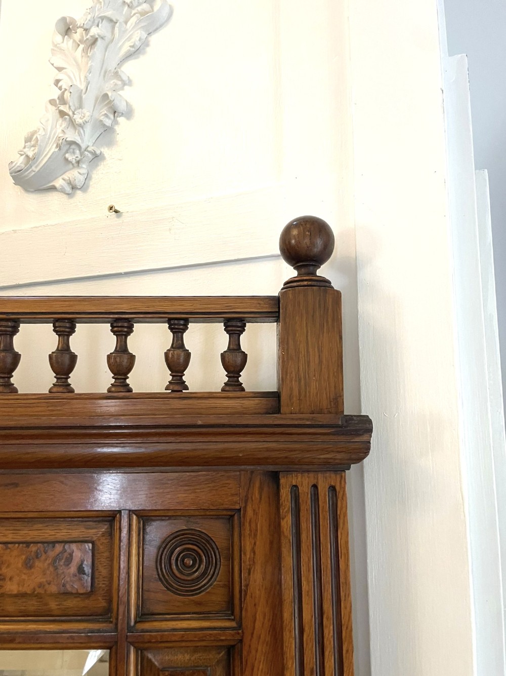 An antique Victorian pollard oak mirror-back sideboard featuring carved field panels, spindled galleries, and multiple mirrored sections. View X