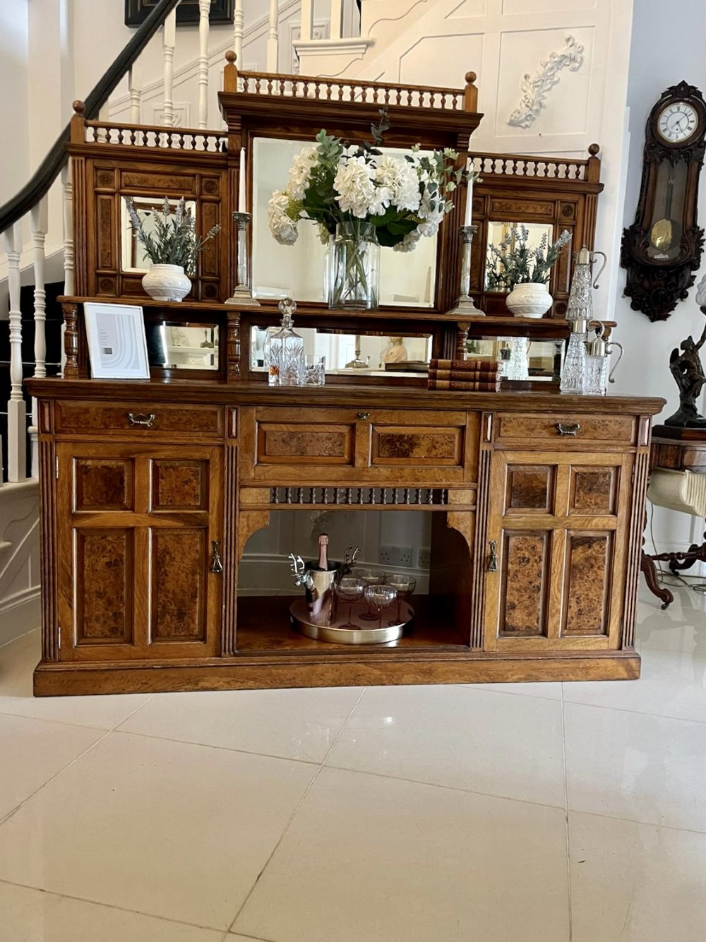 An antique Victorian pollard oak mirror-back sideboard featuring carved field panels, spindled galleries, and multiple mirrored sections. View XIII
