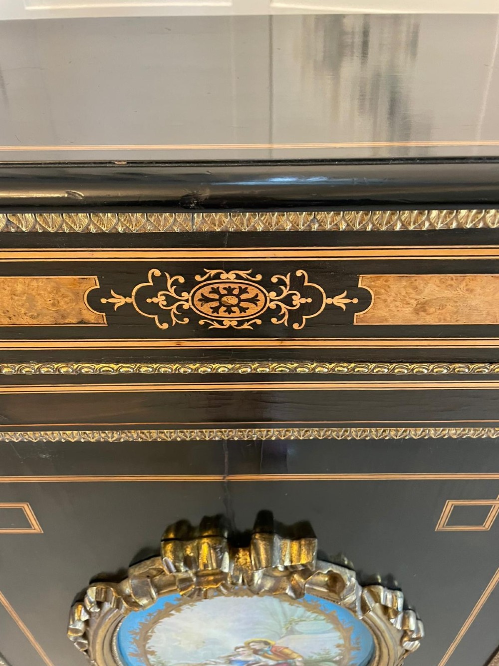 An ebonised nineteenth-century French credenza featuring amboyna wood inlays, gilt-bronze mounts, curved glass door cabinets, and a central painted porcelain plaque. View II