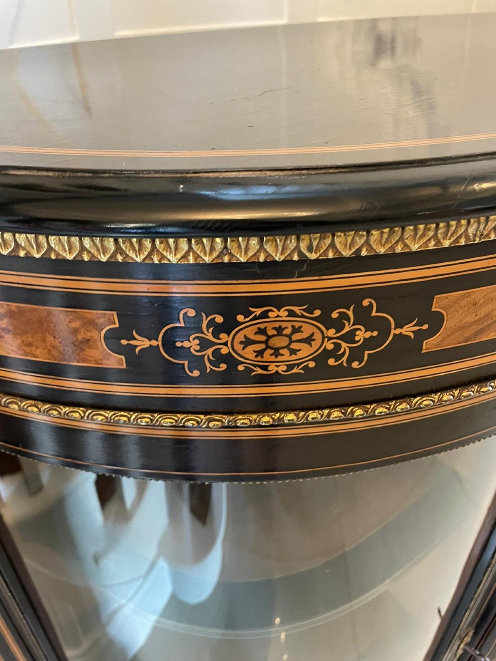 An ebonised nineteenth-century French credenza featuring amboyna wood inlays, gilt-bronze mounts, curved glass door cabinets, and a central painted porcelain plaque. View III
