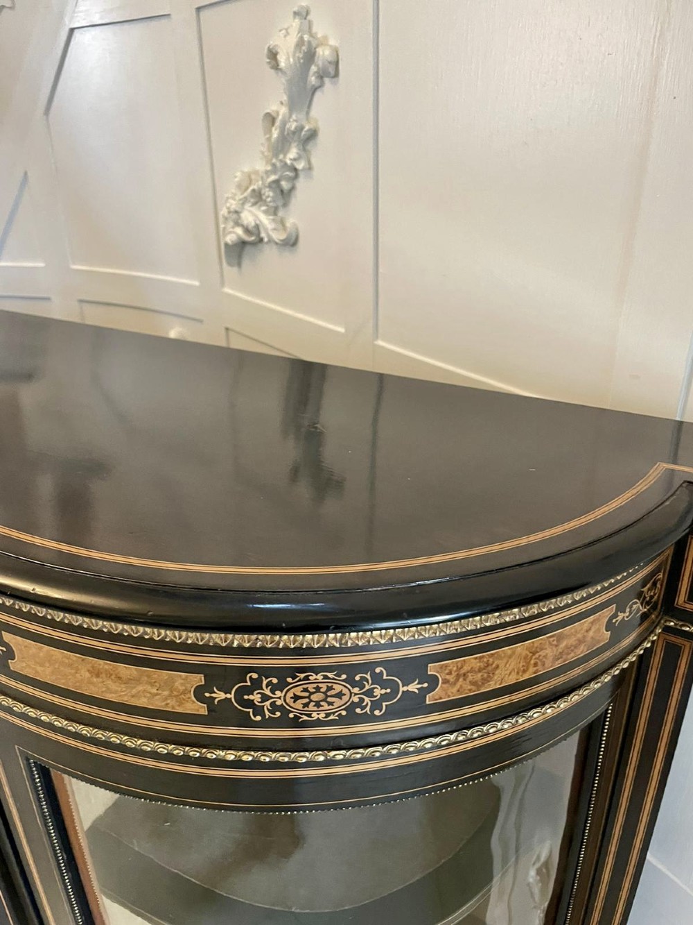 An ebonised nineteenth-century French credenza featuring amboyna wood inlays, gilt-bronze mounts, curved glass door cabinets, and a central painted porcelain plaque. View VII