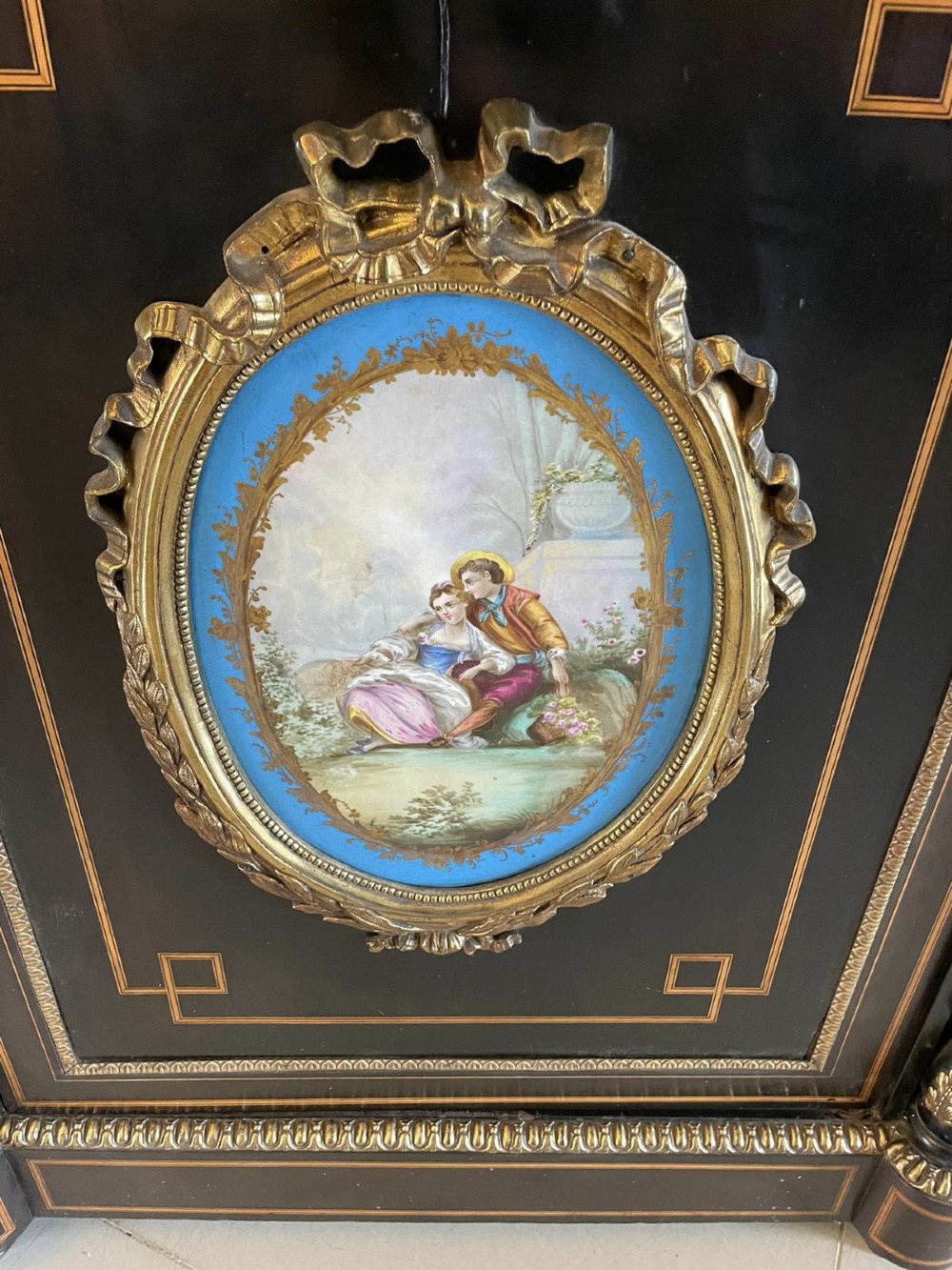 An ebonised nineteenth-century French credenza featuring amboyna wood inlays, gilt-bronze mounts, curved glass door cabinets, and a central painted porcelain plaque. View XIII