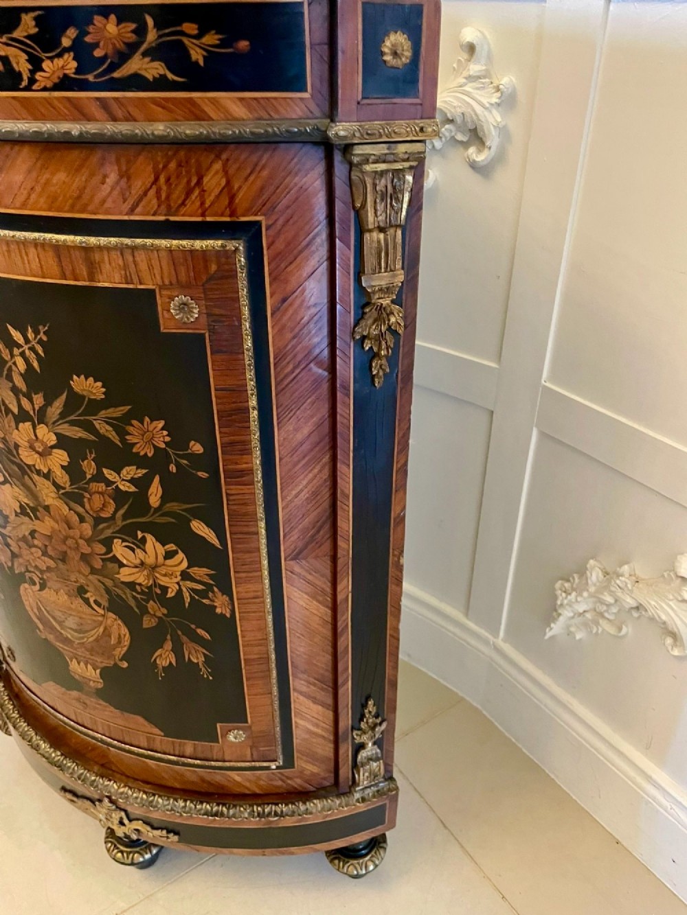 A French Louis XVI style corner cabinet featuring a bow-front door with floral wood marquetry inlay, gilt bronze mounts, and a fitted white marble top. View VII