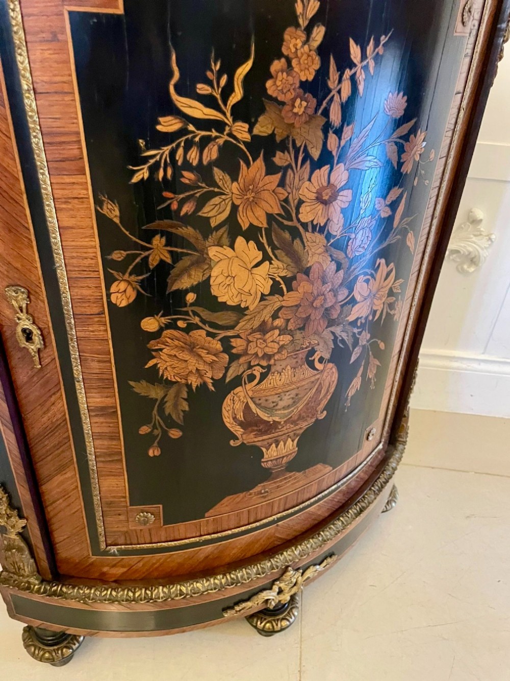 A French Louis XVI style corner cabinet featuring a bow-front door with floral wood marquetry inlay, gilt bronze mounts, and a fitted white marble top. View VIII