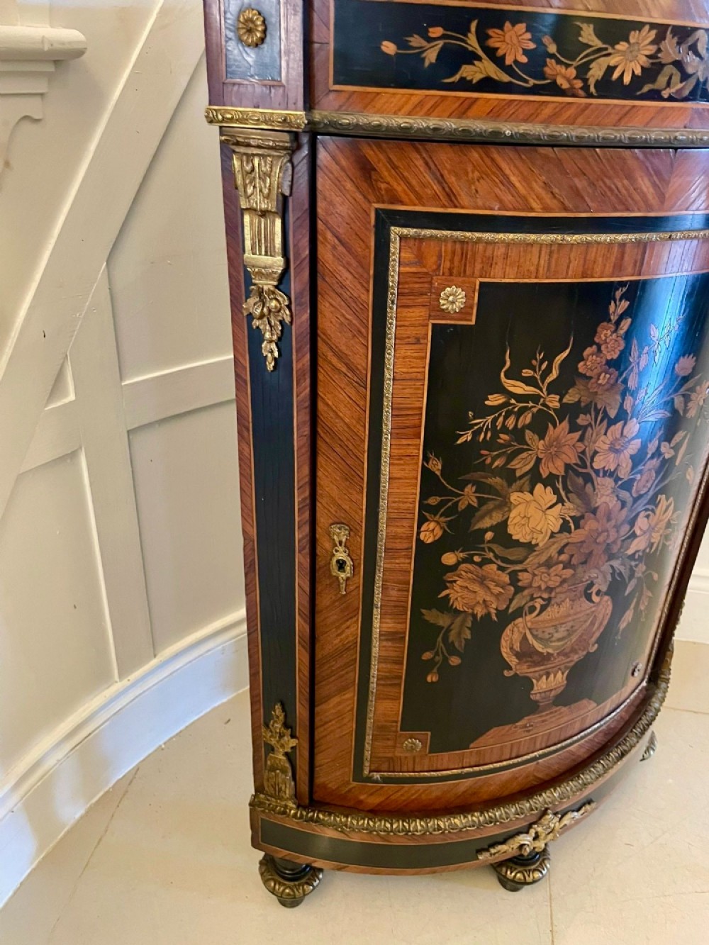 A French Louis XVI style corner cabinet featuring a bow-front door with floral wood marquetry inlay, gilt bronze mounts, and a fitted white marble top. View IX