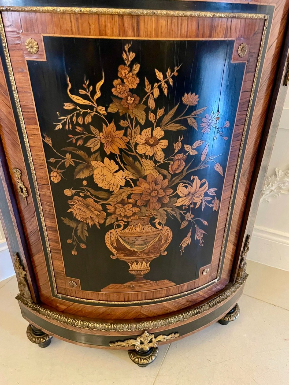 A French Louis XVI style corner cabinet featuring a bow-front door with floral wood marquetry inlay, gilt bronze mounts, and a fitted white marble top. View X