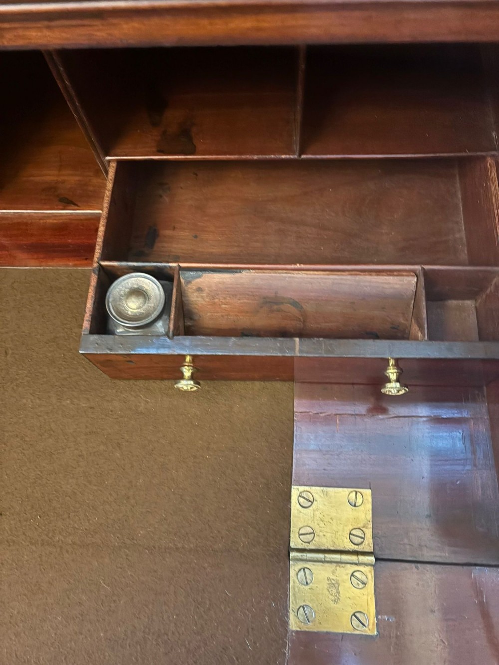An antique Regency mahogany secretaire bookcase with glazed upper doors featuring curved astragal glazing, resting on a base with four drawers and brass hardware. View IX