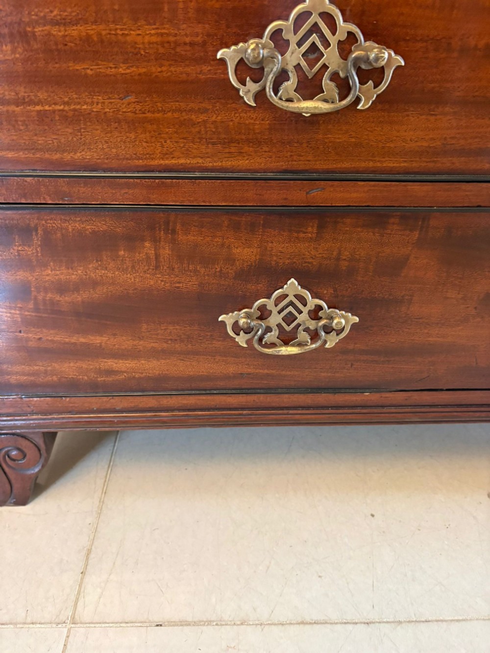An antique Regency mahogany secretaire bookcase with glazed upper doors featuring curved astragal glazing, resting on a base with four drawers and brass hardware. View XI
