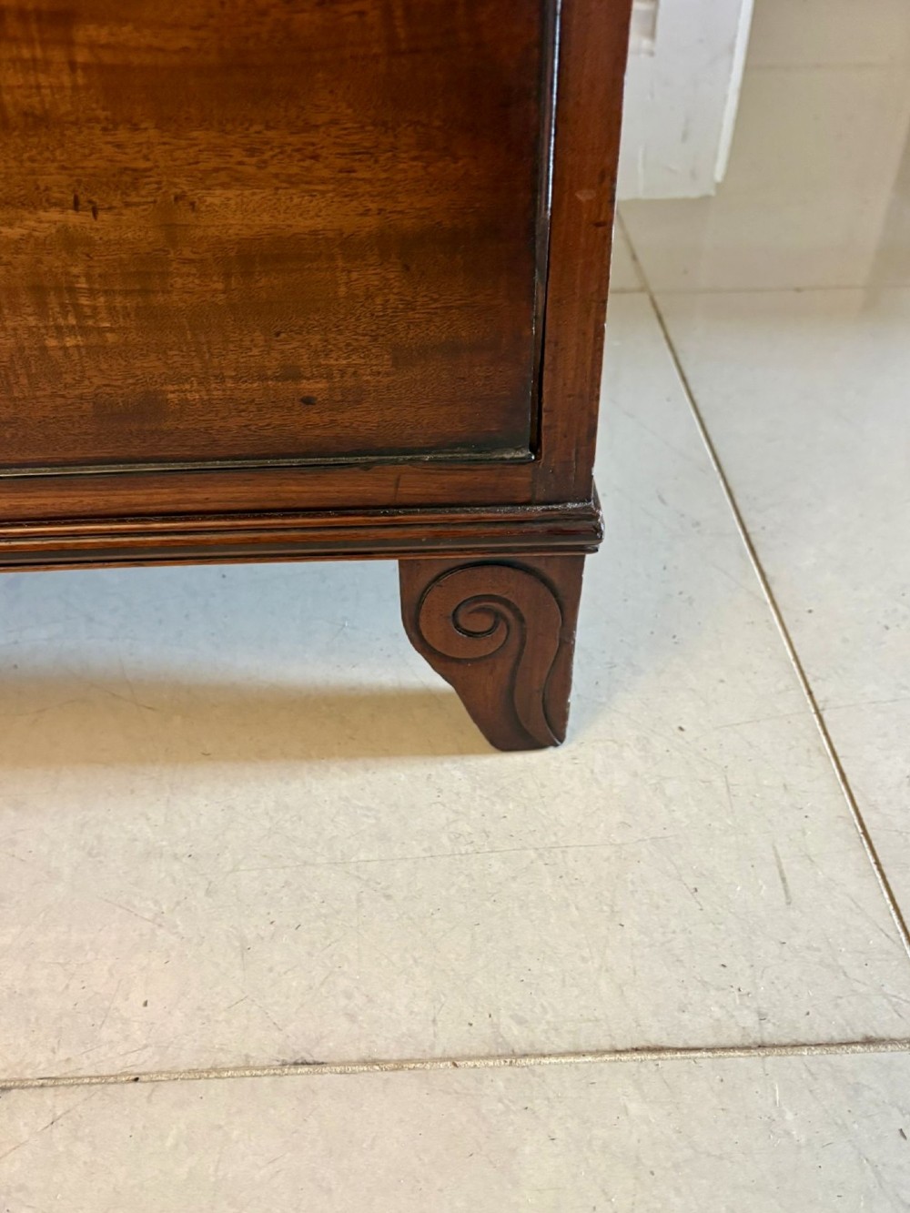 An antique Regency mahogany secretaire bookcase with glazed upper doors featuring curved astragal glazing, resting on a base with four drawers and brass hardware. View XIII