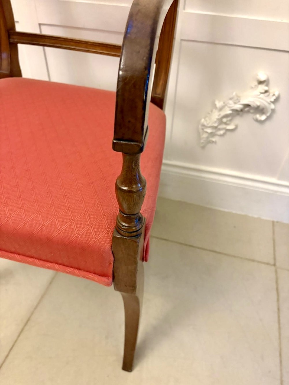 A set of twelve Regency mahogany dining chairs featuring tablet top back rails, carved crossbars, and terracotta fabric upholstered seats, including two carvers with curved armrests. View VII