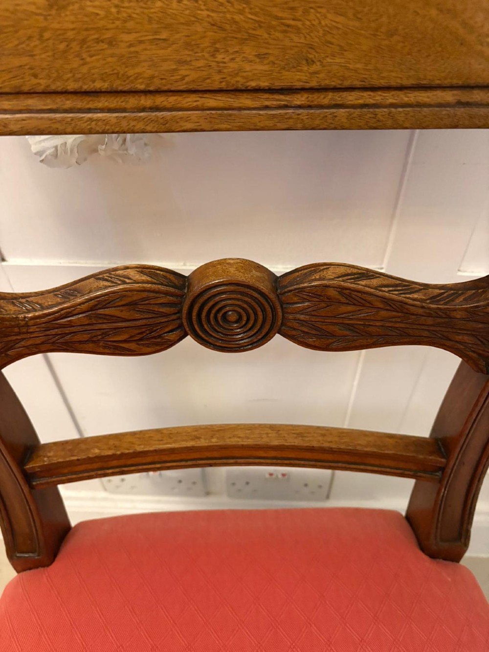 A set of twelve Regency mahogany dining chairs featuring tablet top back rails, carved crossbars, and terracotta fabric upholstered seats, including two carvers with curved armrests. View VIII