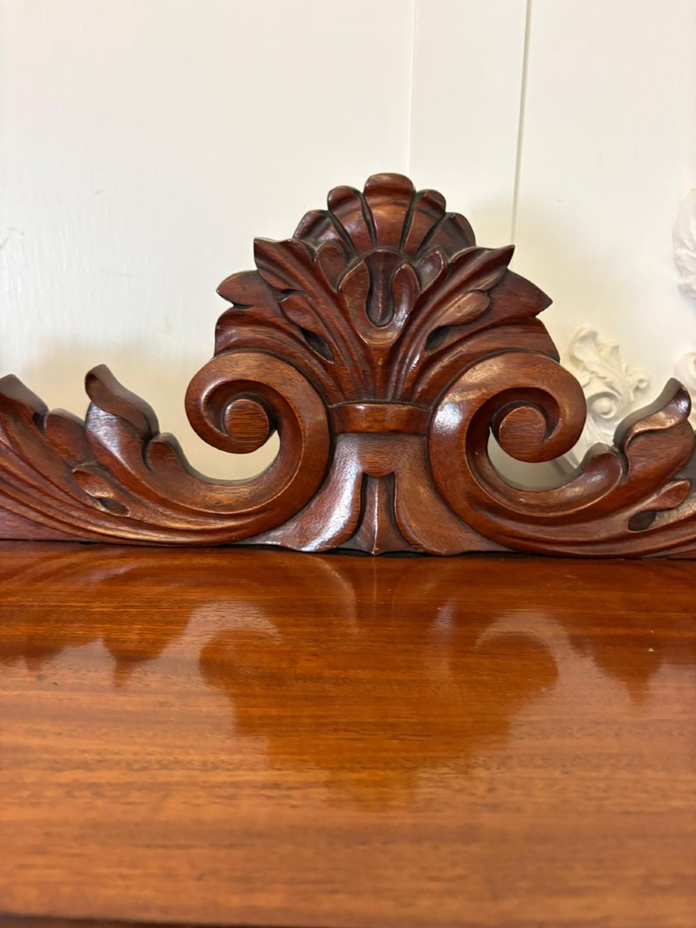 A Victorian mahogany chiffonier featuring a two-tiered upper shelf superstructure with carved scroll supports and a lower cupboard with flame mahogany veneered doors. View III