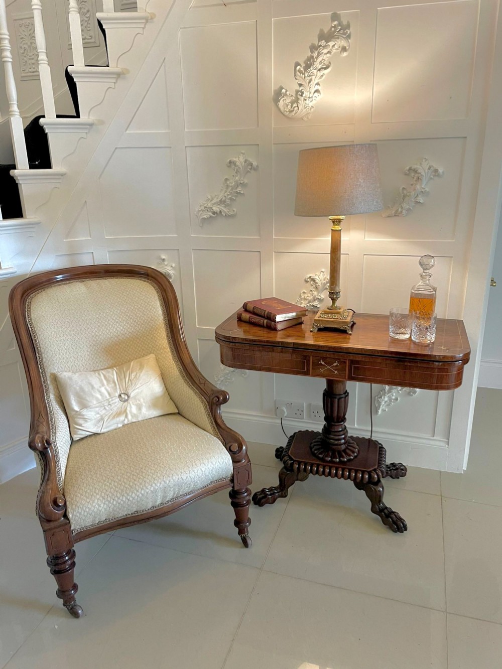 A Regency fold-over rosewood card table with brass inlay, a central pedestal, and carved lion paw feet. View II