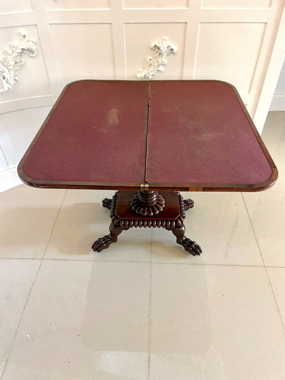 A Regency fold-over rosewood card table with brass inlay, a central pedestal, and carved lion paw feet. View III
