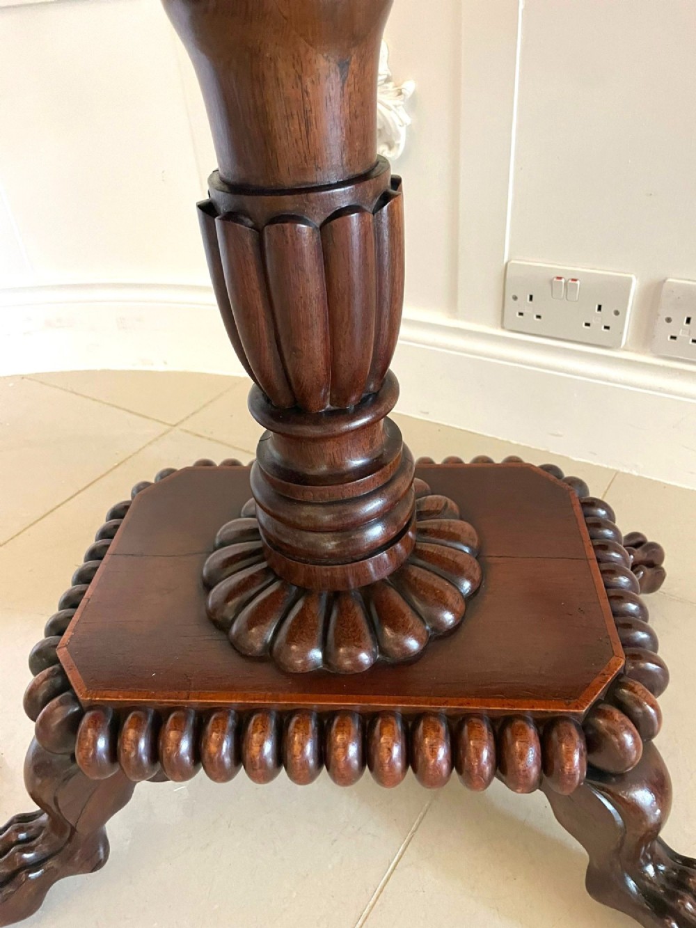 A Regency fold-over rosewood card table with brass inlay, a central pedestal, and carved lion paw feet. View VII